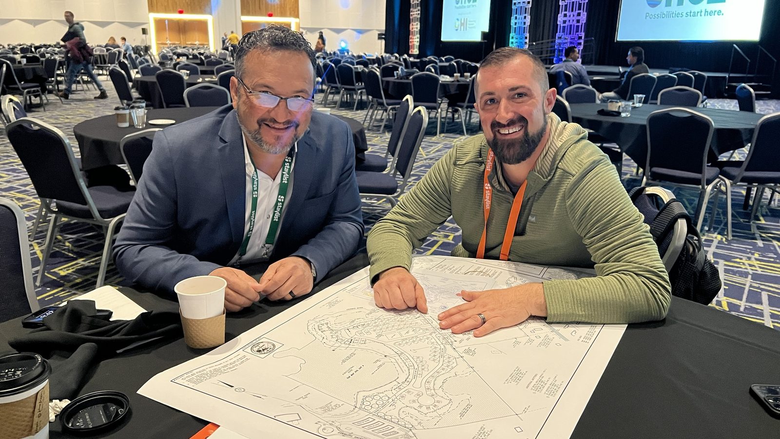 Terry Munoz of Campground Consulting Group reviewing a campground site plan with a colleague at an industry conference